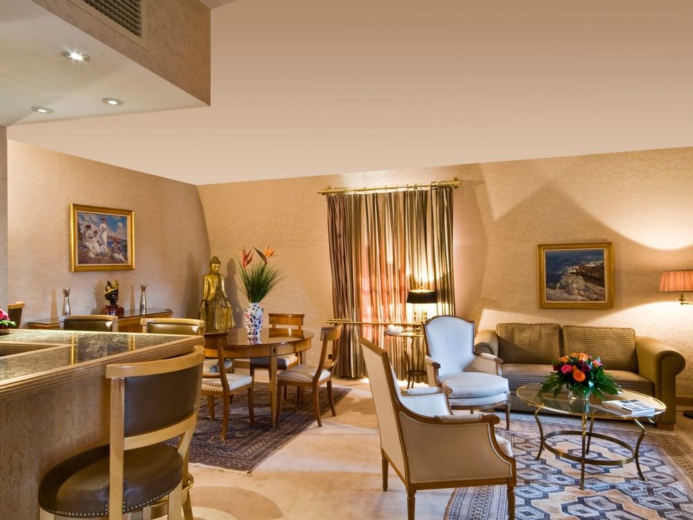 Royal Suite living area with plush sofa near dining table at Warwick Grand Place Brussels