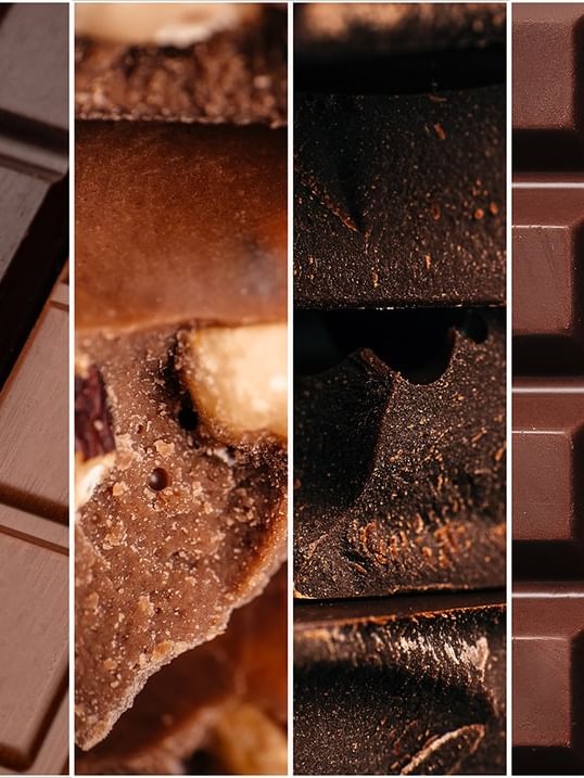 Collection of milk and dark chocolate bars with different textures and nut fillings at Warwick Grand Place Brussels