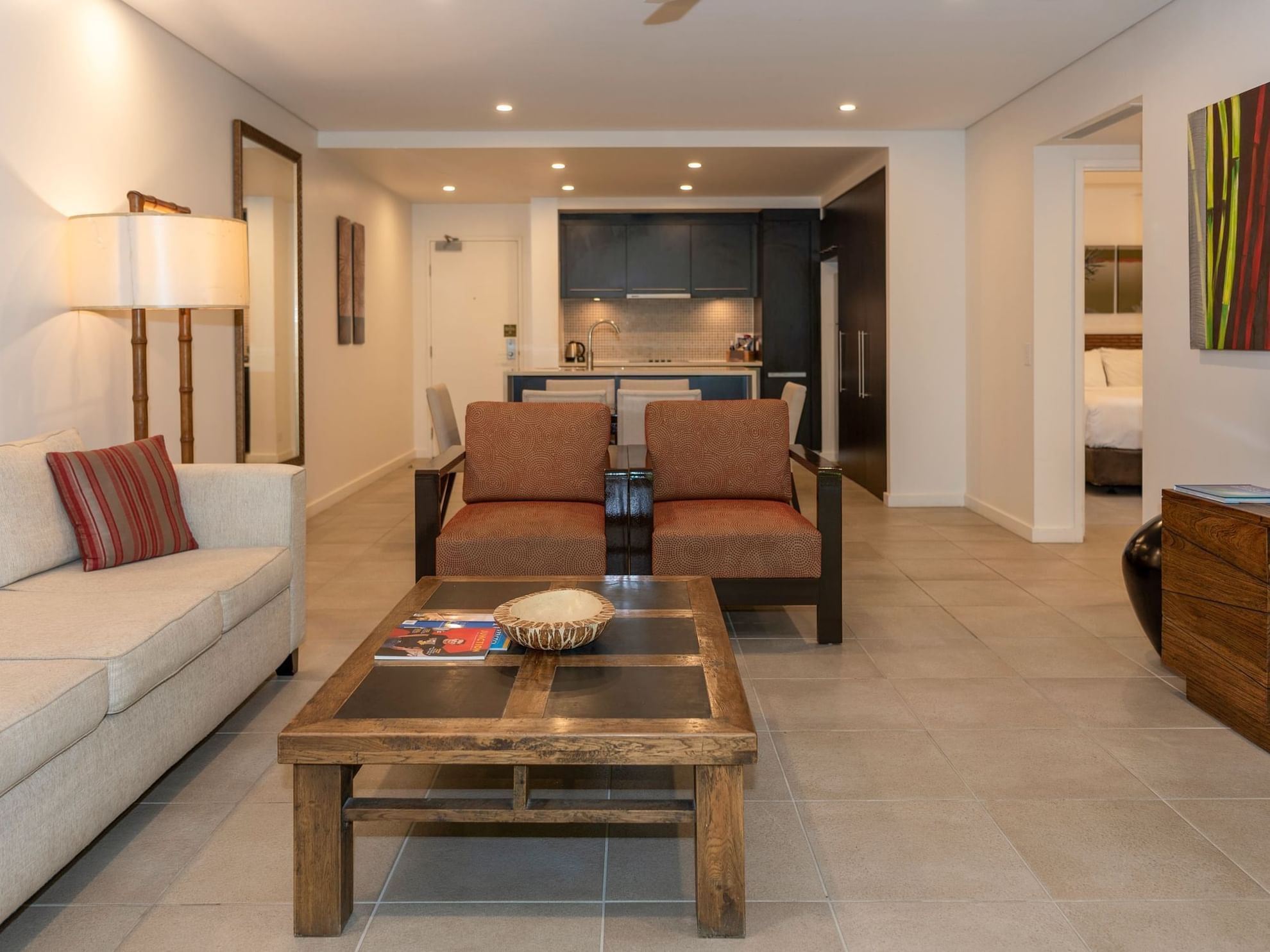 Living area of Two Bedroom Apartment with comfy sofas and coffee table at Pullman Port Douglas Sea Temple Resort & Spa