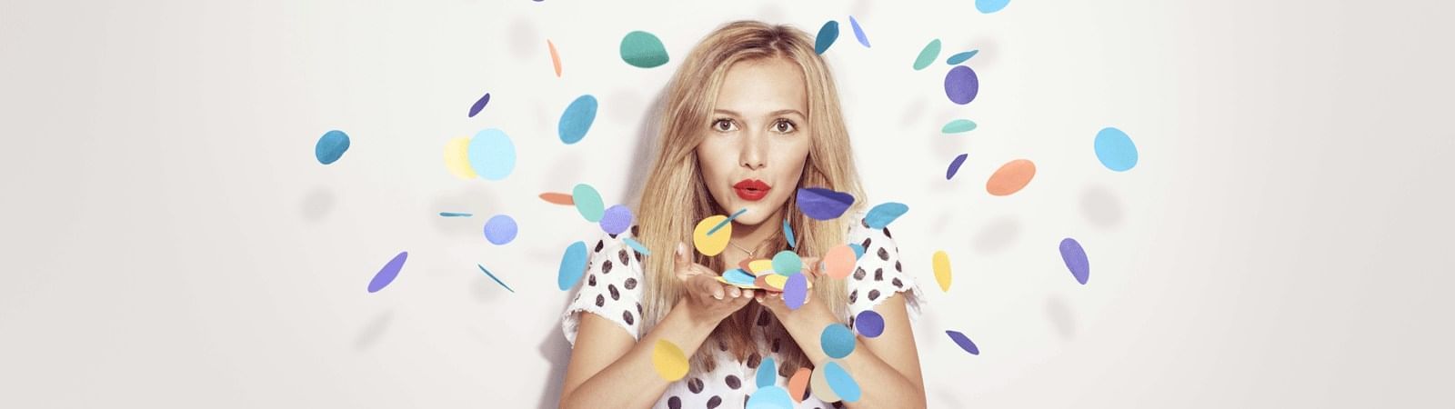 A woman blowing confetti at Novotel Sydney Darling Square