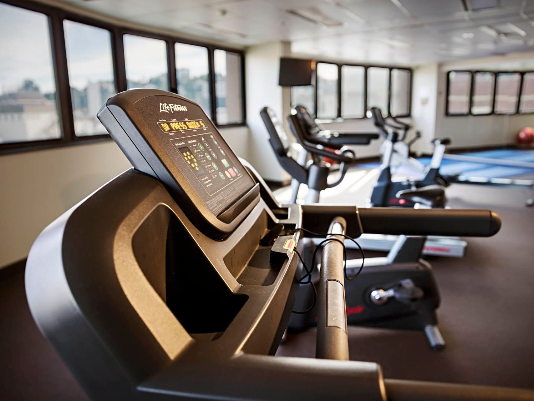 Exercise machines in the Gym overlooking the city at Hotel Grand Chancellor Townsville