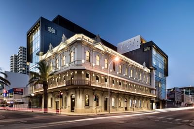 Illuminated exterior of Melbourne Hotel Perth by the street