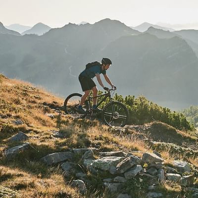 A boy cycling on a mountain near Falkensteiner Hotels