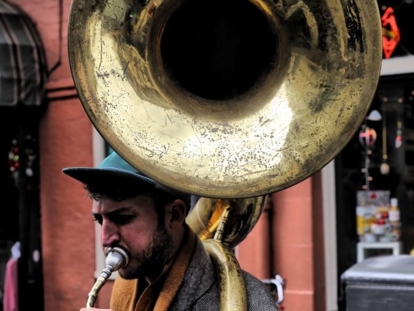 A man playing a tuba in the streets near La Galerie Hotel
