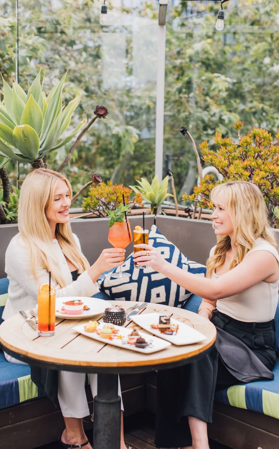 Ladies toasting cocktails in Topside Terrace Kitchen & Bar at Hotel Republic San Diego