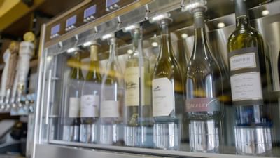 Wine bottles on a shelf in the bar at The Nest Palo Alto