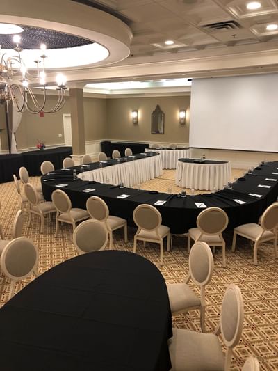 U-shape meeting setup with chairs facing a blank projection screen in the Laurel Ballroom at The Simsbury Inn