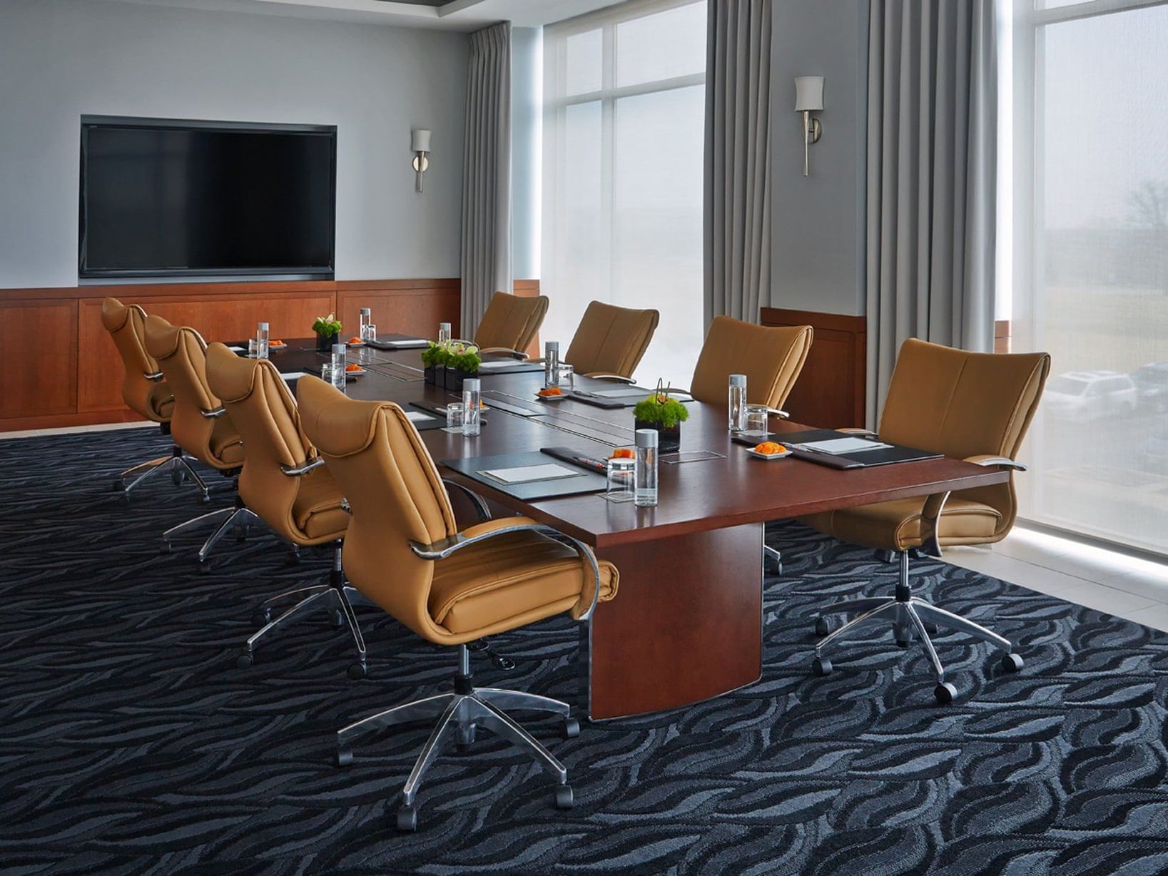 Long meeting table with chairs in Athens Mykonos Event Space at Hotel Arista, Naperville.