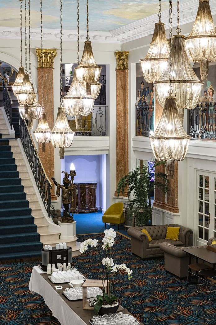 Spacious lobby area with chandeliers and seating at Oceania Hotels