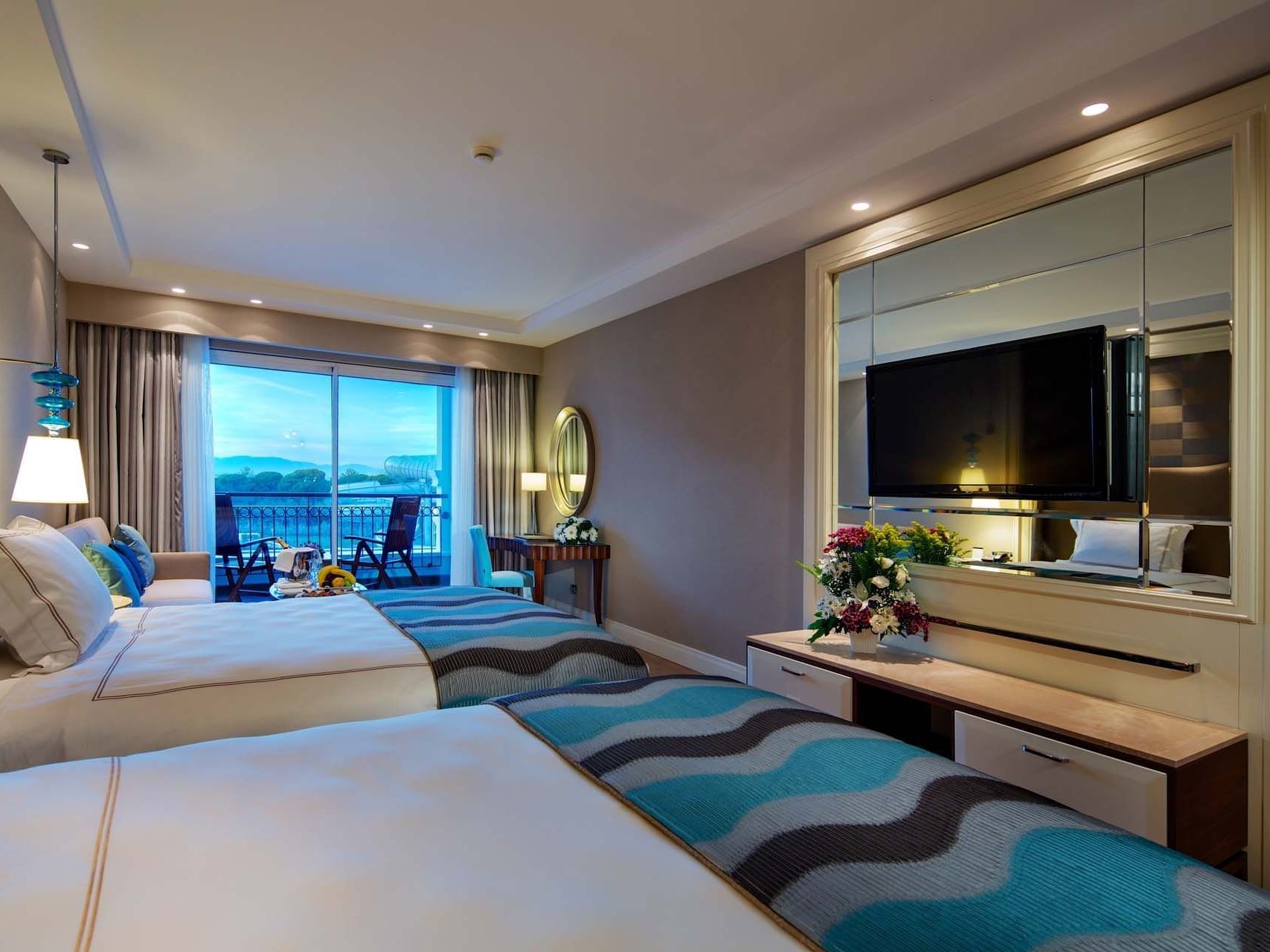 Sitting area & TV by the beds in Standard Room at Titanic Deluxe Golf Belek