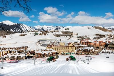 Snowy mountain town with ski lifts and buildings at Elevation Resort and Spa.