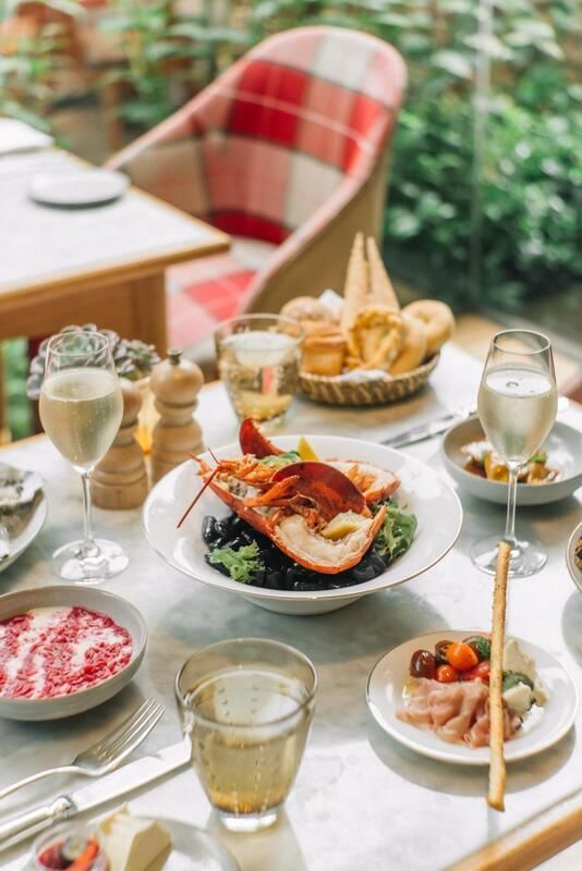 Lobster dish, assorted appetizers, and champagne served during Opera Sunday Brunch at Park Hyatt Saigon
