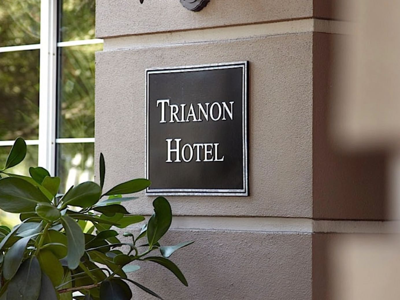 Trianon Hotel sign board on a wall at Trianon Bonita Bay