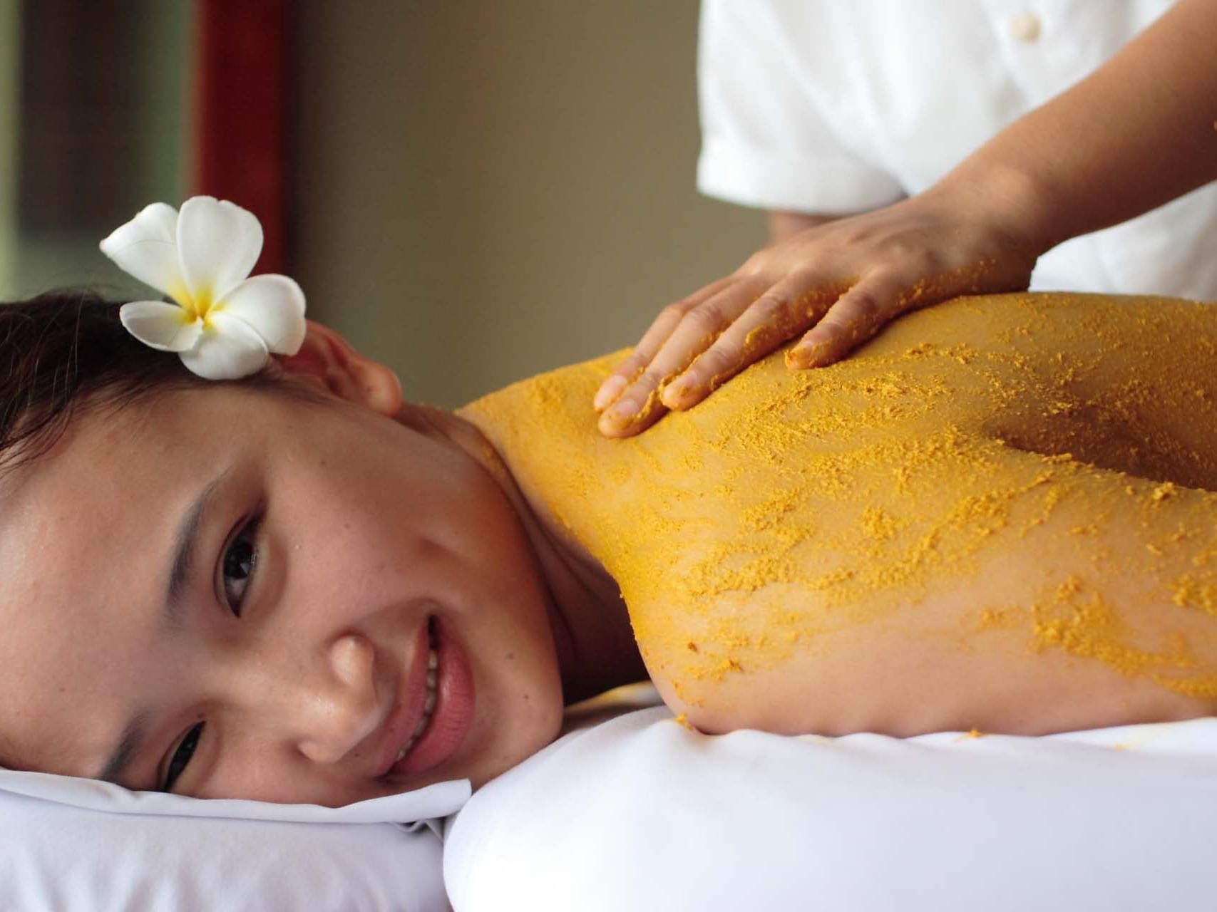 A girl having scrub in Mandara Spa at Palau Royal Resort