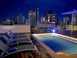 chairs facing a rooftop pool