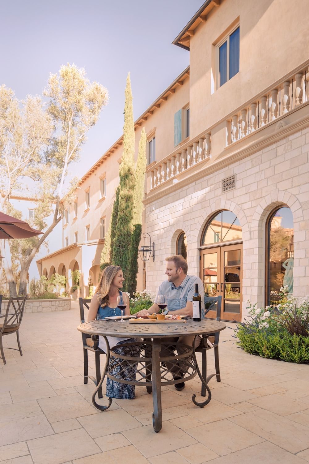 Lorem ipsum A couple enjoying a meal in the courtyard of Allegretto Vineyard