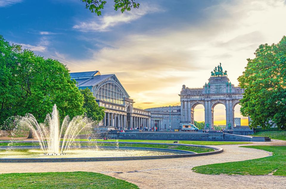 Scenic view of the Cinquantenaire Arch and fountain at sunset near Hotel Barsey by Warwick
