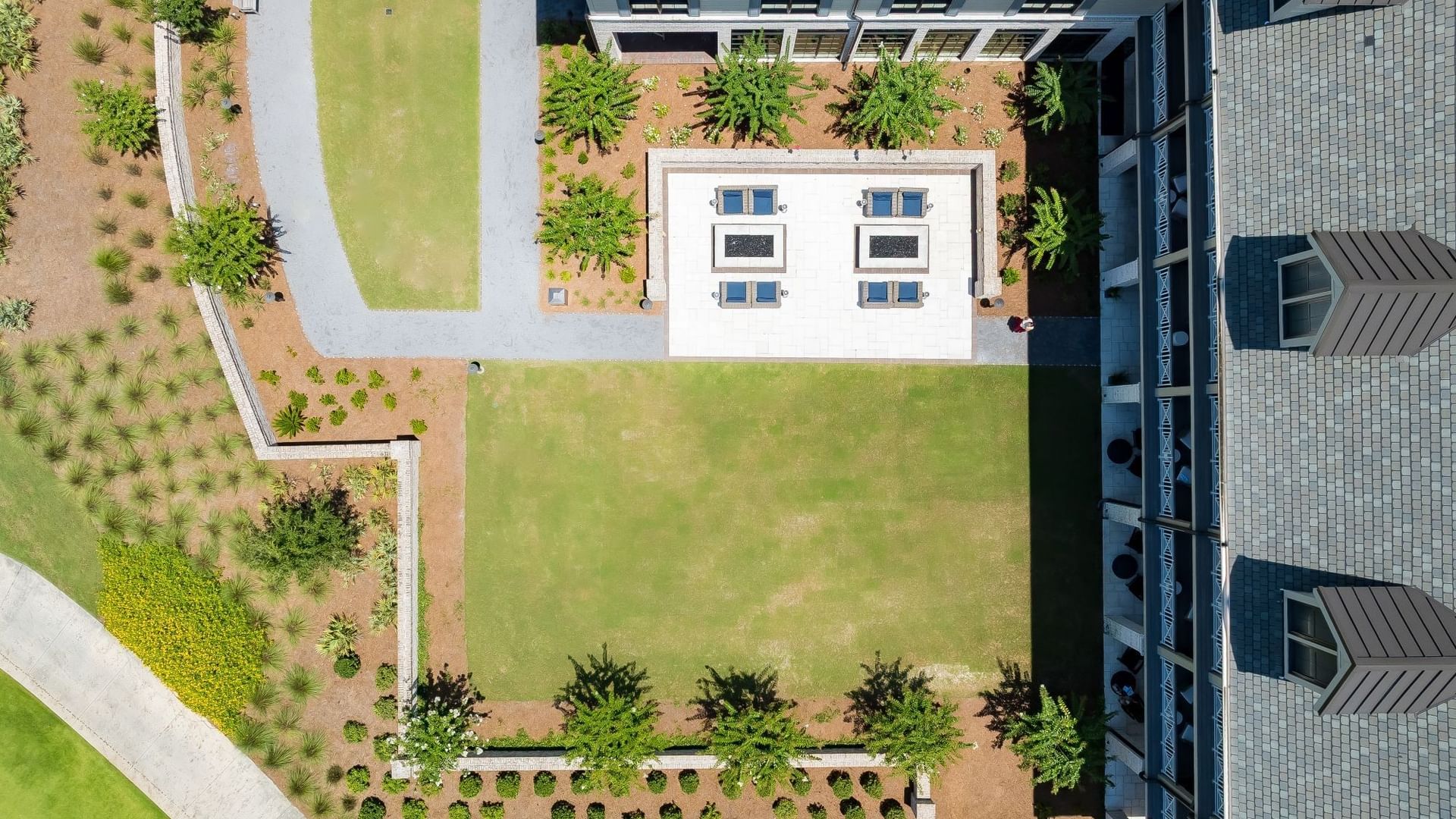 Aerial view of 1936 Lawn featuring manicured green space, white pavilion, and landscaped borders at Camp Creek Inn.