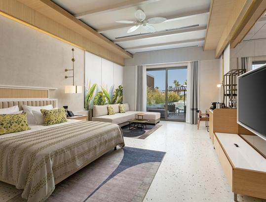 TV & seating area by the bed in Lagoon Beach Swim-up Room at Cullinan Belek