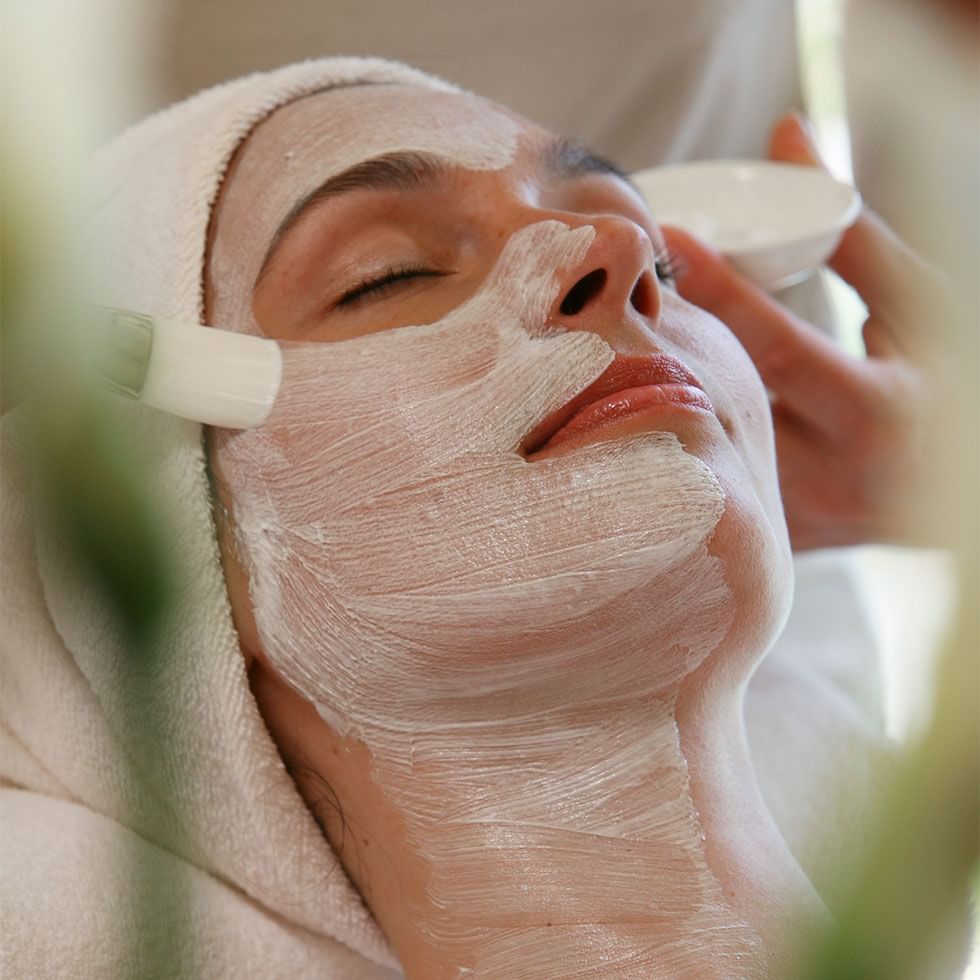 Woman having a facial in a spa at Falkensteiner Hotels