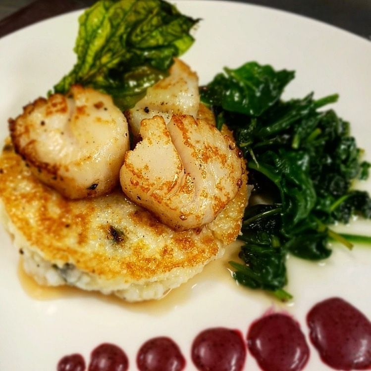 Pan-seared sea scallops on risotto cake with spinach and berry sauce drops at Clemson University Conference Center & Inn