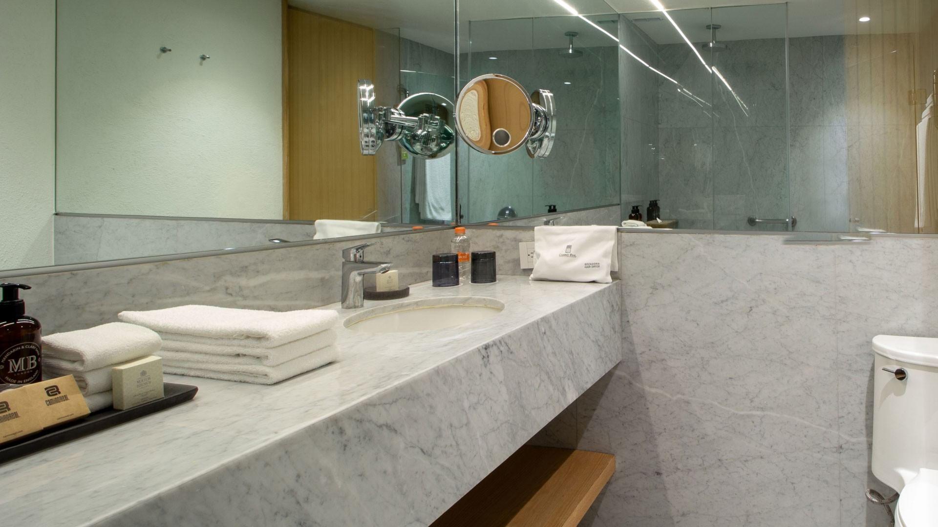 King Superior Camino Real Club marble bathroom featuring a large mirror, and glass shower at Camino Real Polanco Mexico