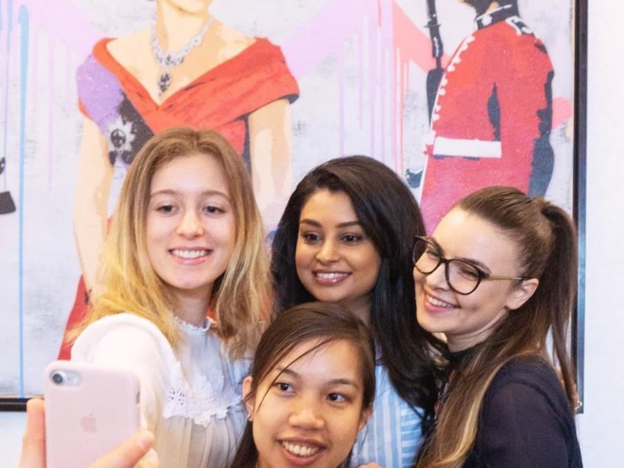 Group of girls getting a selfie at St. Giles London hotel lobby