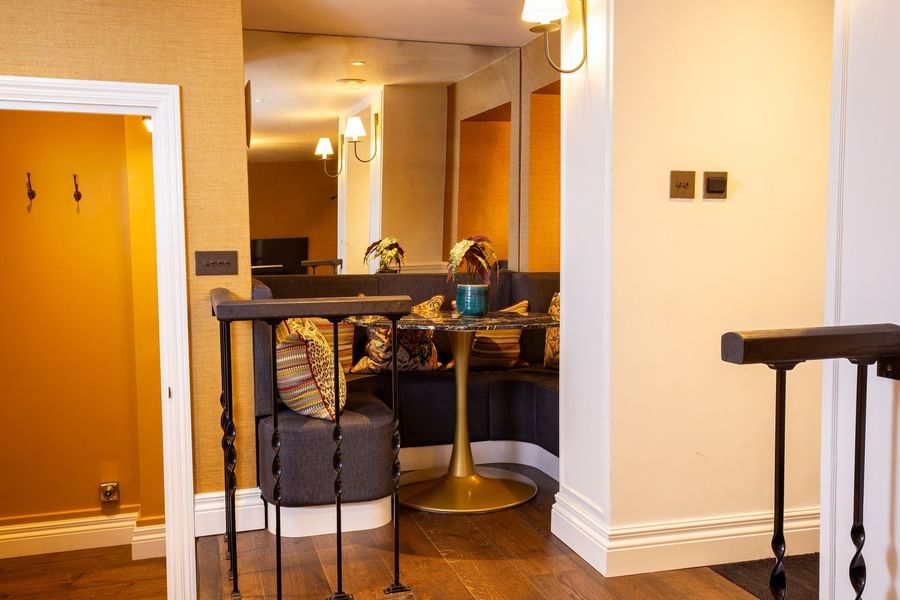 Corner dining nook with marble table & mirror wall in Hyde Park Suite at The Capital Hotel, Apartments and Townhouse