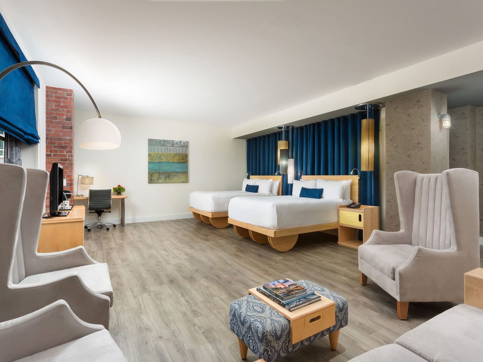 two beds and chairs in a hotel room