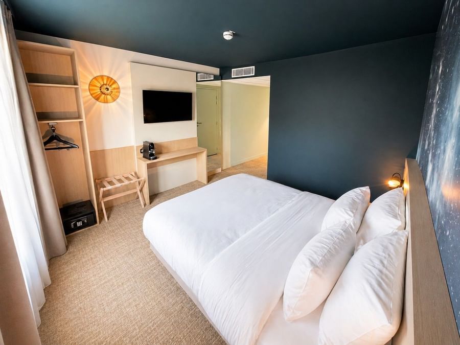 Suite junior élégante avec lit king-size et télévision à l'Osmo Hôtel à Chantepie.