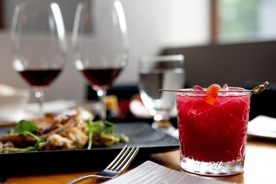 Closeup of a drink beside a dish served at ReStays Ottawa