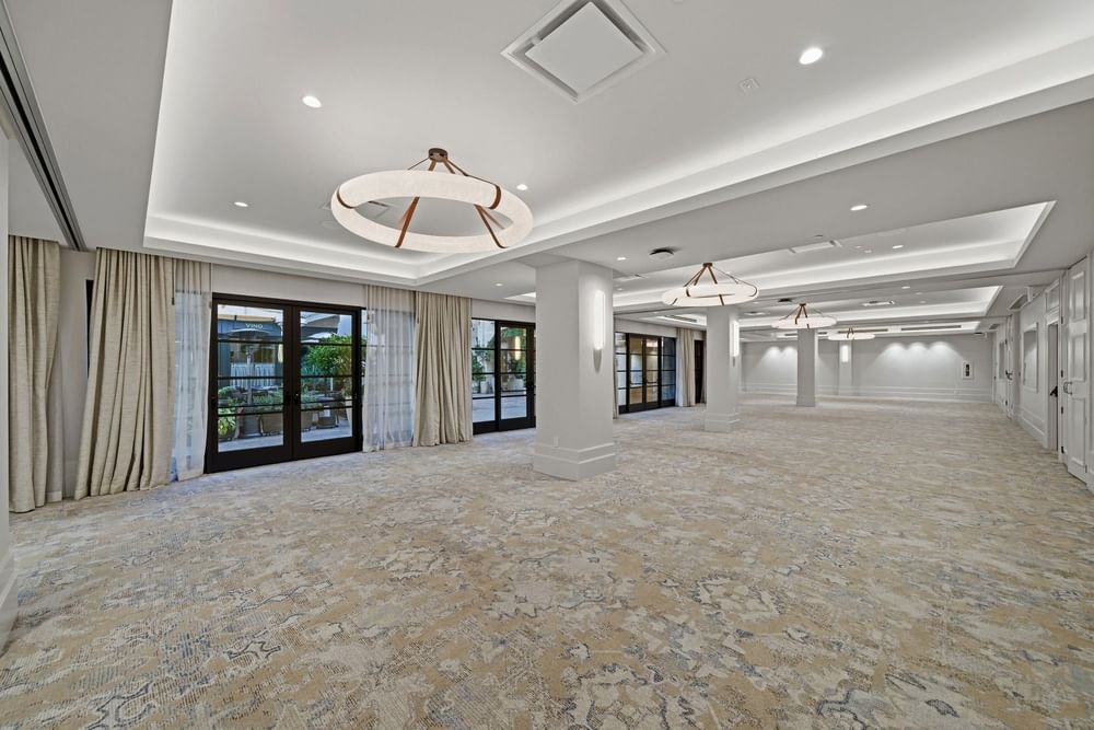 empty ballroom with neutral color tones and natural light pouring in