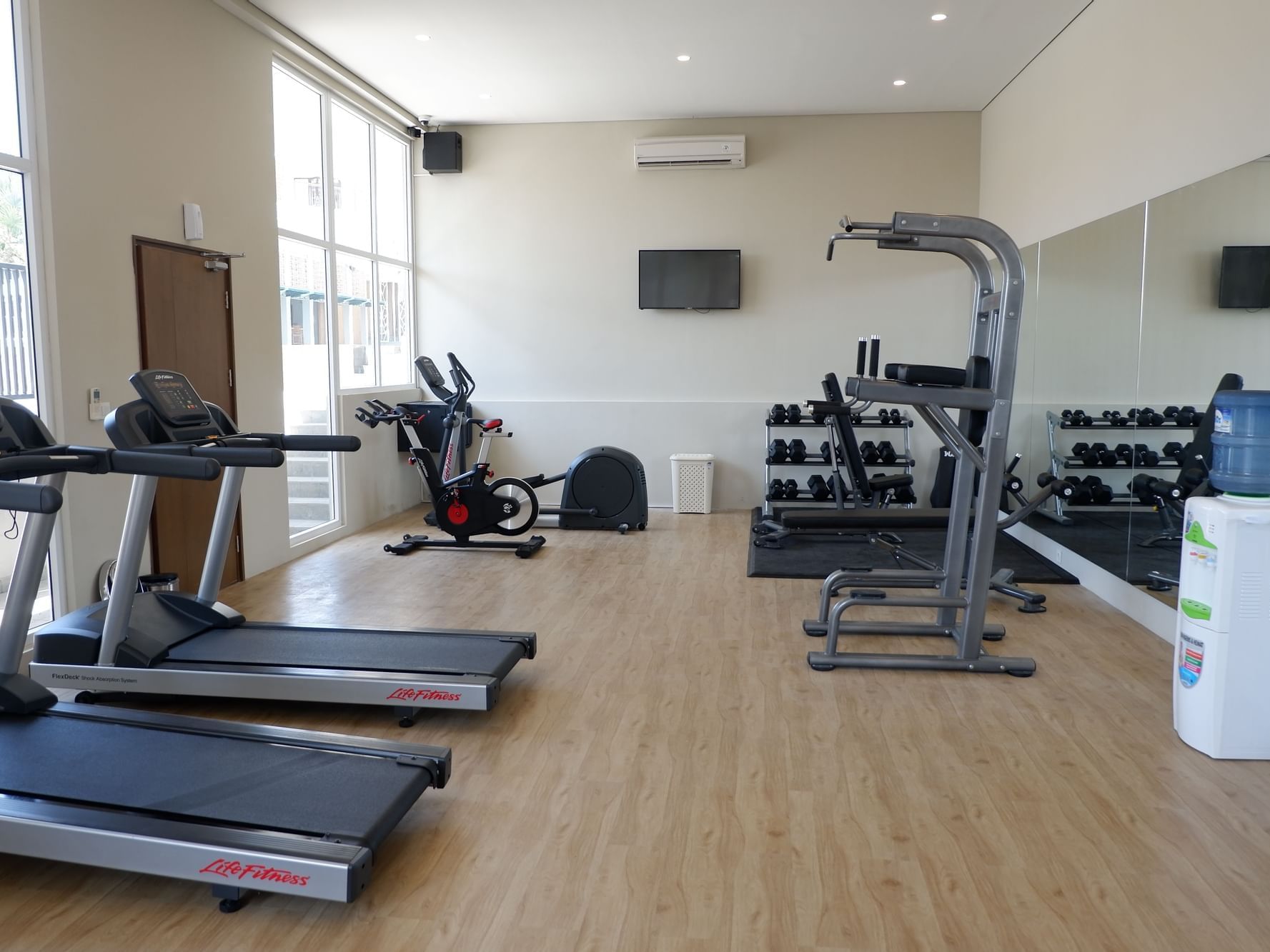 Interior of fitness center with lined treadmills at Eastin Ashta Resort Canggu