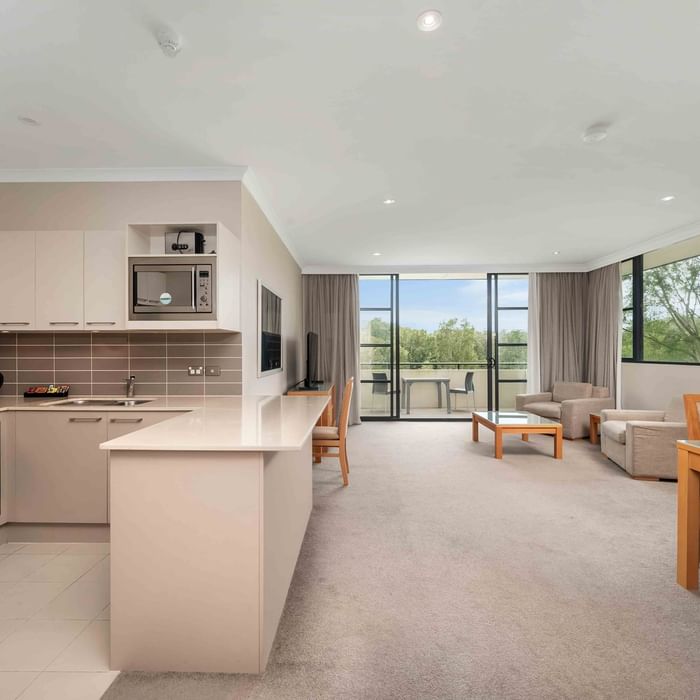 kitchen, dining and living are in a deluxe apartment with a balcony