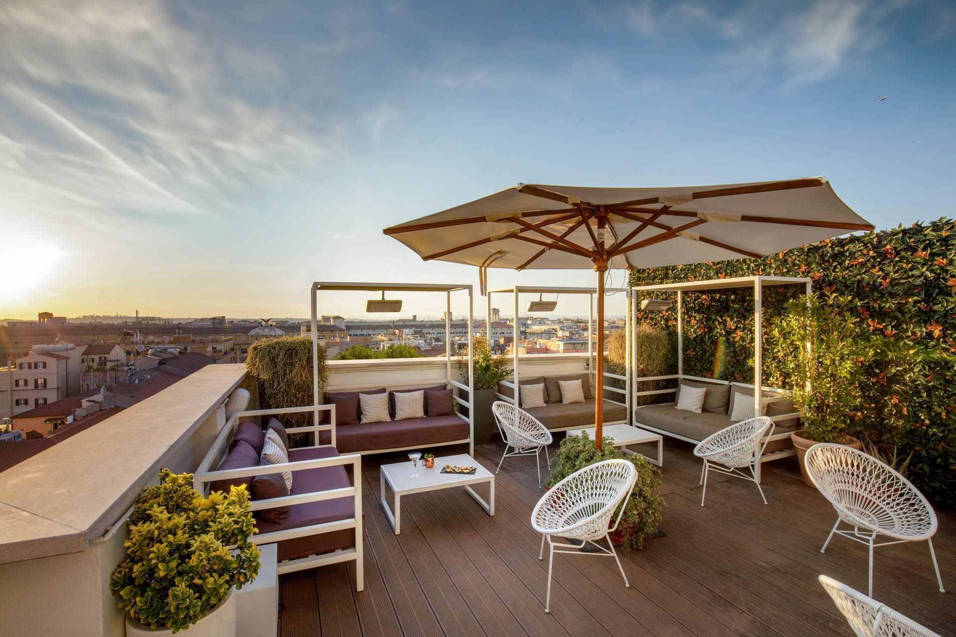 Breakfast with a View of Rome, rooftop dining with sofas under the umbrellas, overlooking the city at The Independent