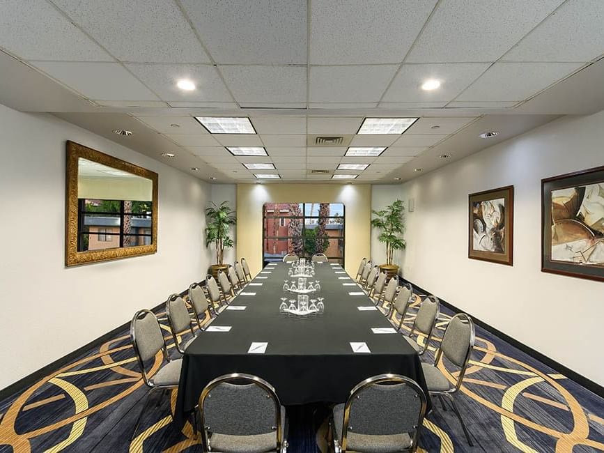 Long table arranged for a meeting in Executive Boardroom at Alexis Park Resort