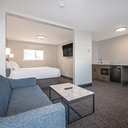 Spacious King Suite featuring a living area with sofa and a full kitchen