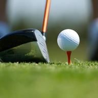 Close up of golf ball on tee and club