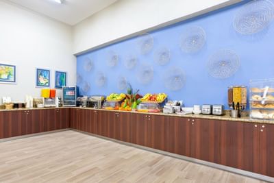 Breakfast buffet featuring a variety of fruits, pastries & beverages at Irazu Hotel