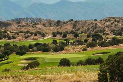 Expansive Piñon Nine course at Towa Golf Club near Hilton Santa Fe Buffalo Thunder, with distant mountain views