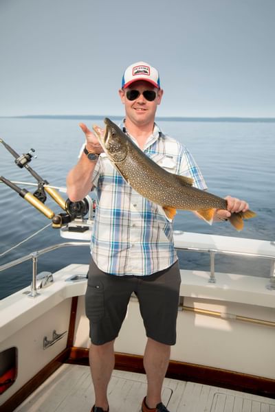 Man holding a large fish in Lake Michigan