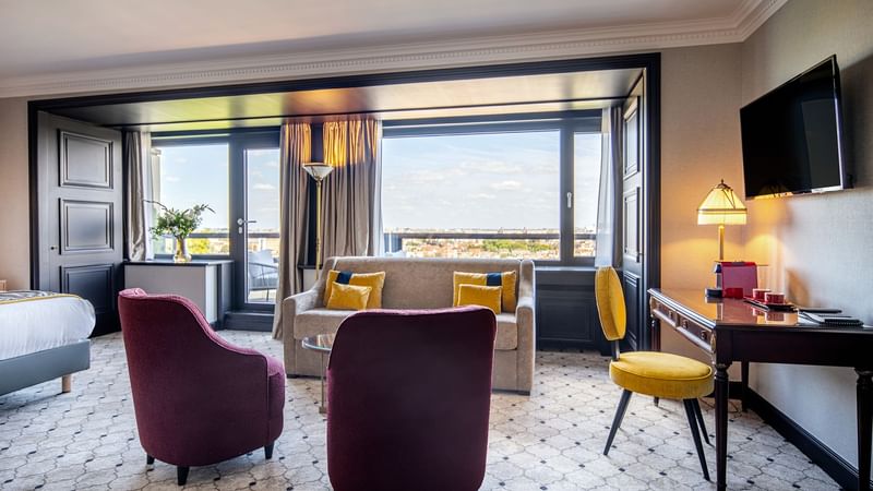 Living room with TV & city view in Junior Suite at Hotel Barsey by Warwick - Brussels