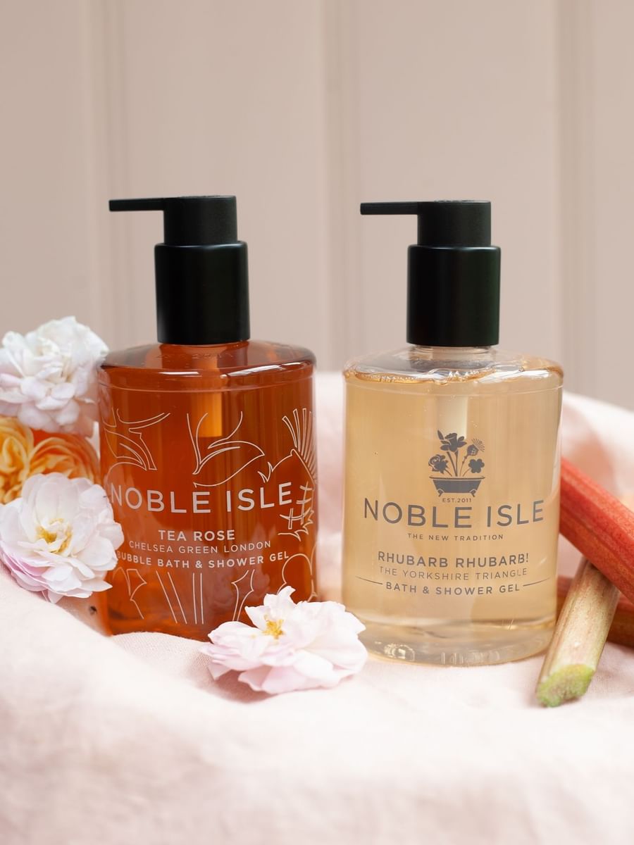 Close-up of Noble and Isle bath & shower gel bottles on a table at The May Fair Hotel