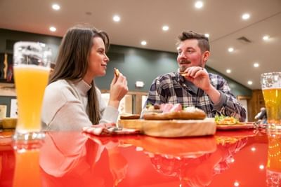 Couple having a meal at restaurant in The Lodge at Schroon Lake