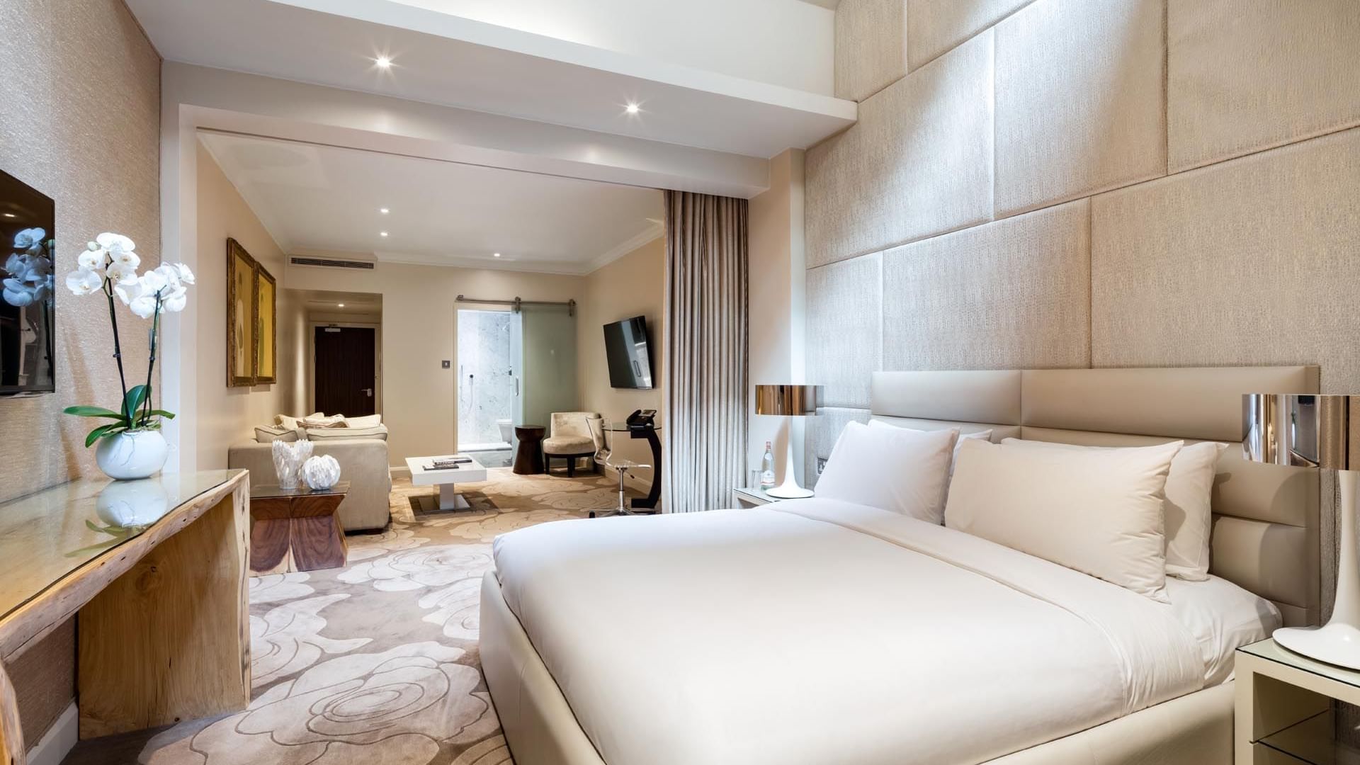 Luxurious Studio Suite at The May Fair Hotel featuring a plush bed, elegant décor, and soft lighting