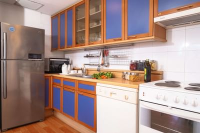 Kitchen with a refrigerator & a gas stove at Hanoi Daewoo Hotel