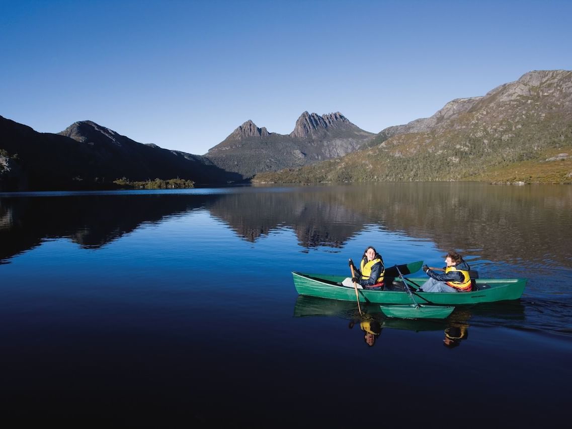 Couple on a Canoe boat at dove lake near Cradle Mountain Hotel 