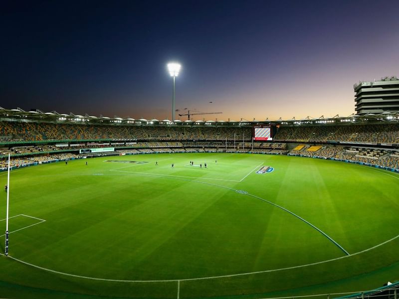 Twilight view of The Gabba with lit floodlights and a clear sky naerSofitel Brisbane Central