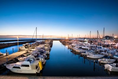 Boats docked by the pier near Be Fremantle