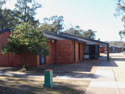 Row of brick units with tree and walkway in front at La Trobe University - Terraces.